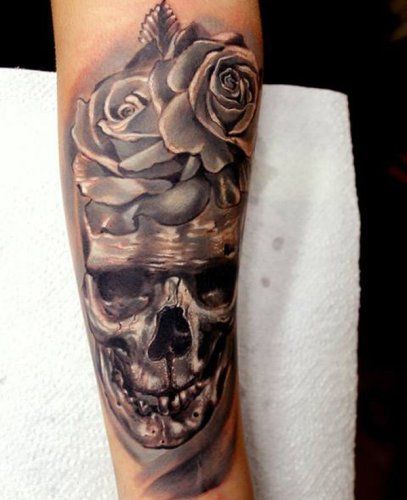 Skull and roses forearm tattoo
