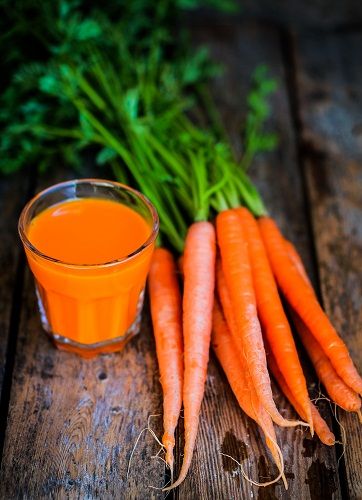 Frissen facsart carrot juice on wooden background