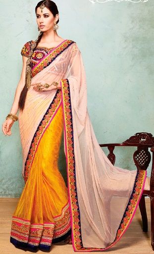 15. Yellow silk and net saree with heavy embroidery stone work