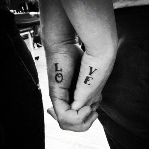 Ljubezen lettering couple tattoo