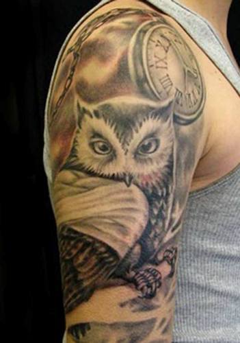 Owl in arms tattoo