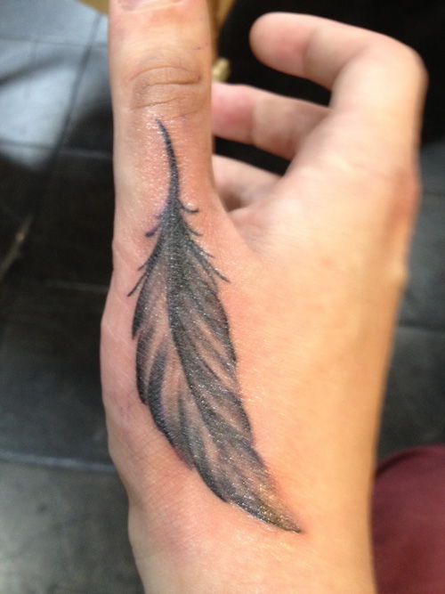 A feather hand tattoo