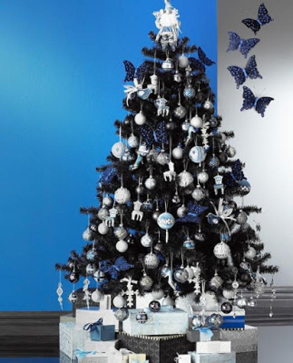 argint blue Christmas tree decorated with non-traditional ornament butterfly