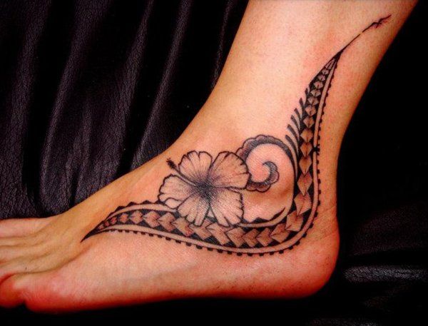 The feminine Polynesian inspired tattoo features style and elements Samoan Tatau, lily flower, spear heads.