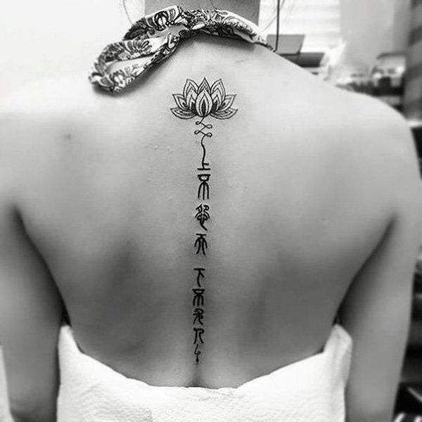 Lotus and fonts spine tattoo-24