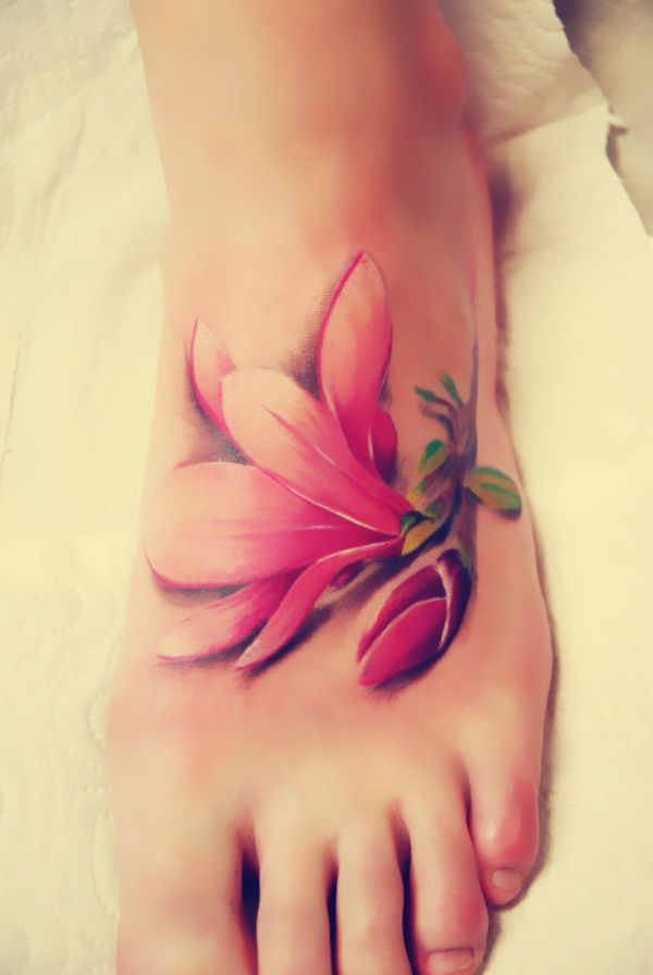 The realistic magnolia tattoo looks like a piece of flower falls on the foot