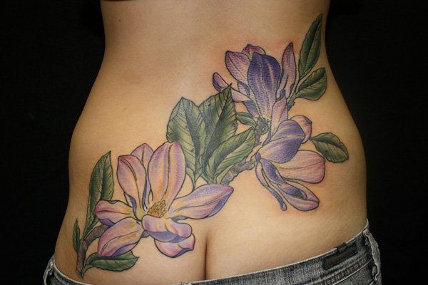 Magnolias tattoo on low back
