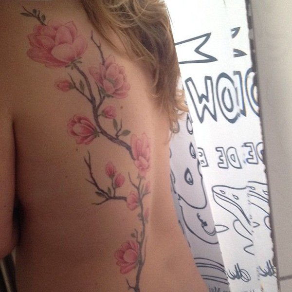 Magnolia flower tattoo on back