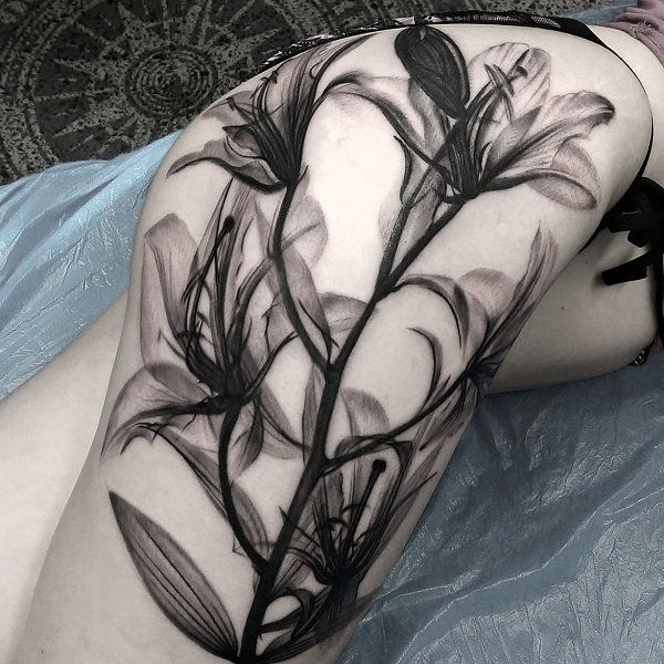 Juoda and white lily tattoo by Matt Jordan