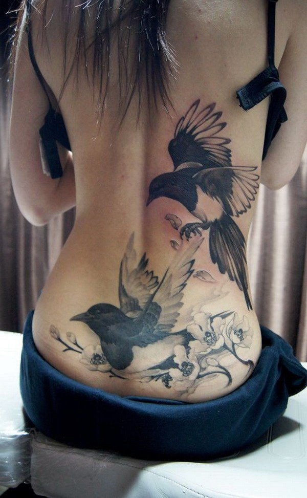 Realist lower back bird tattoo