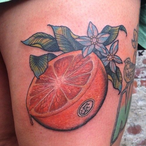 Pusė Orange with Green Leaves Tattoo Design
