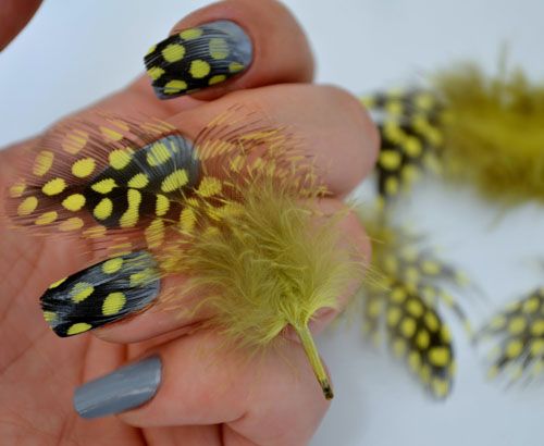 Galben and black dotted feather nail art