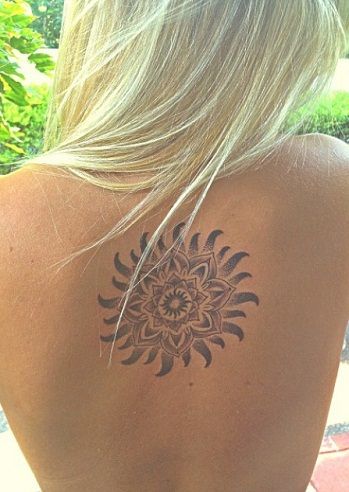 Lotus centered Tribal sun tattoo