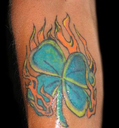 Spalvinga clover tattoo with flame design