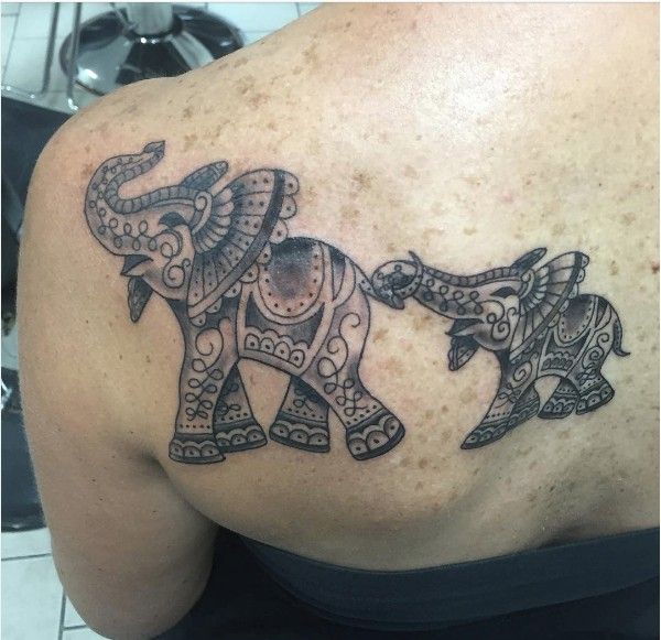 34 elephant family tattoo on shoulder blade