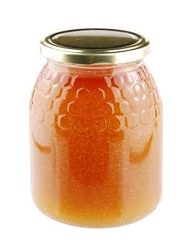 Naminis honey in a glass jar on white