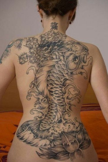 Fish and cherry blossom girl tattoo