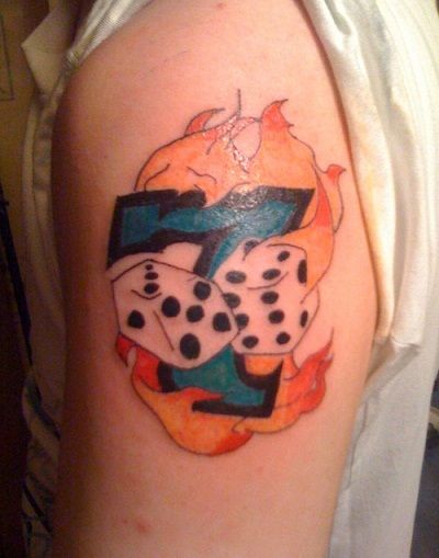 Lucky number dice tattoo on flames